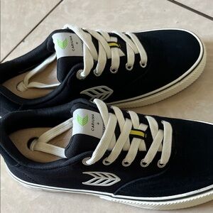 Cariuma Black and White Sneakers with Green Logo